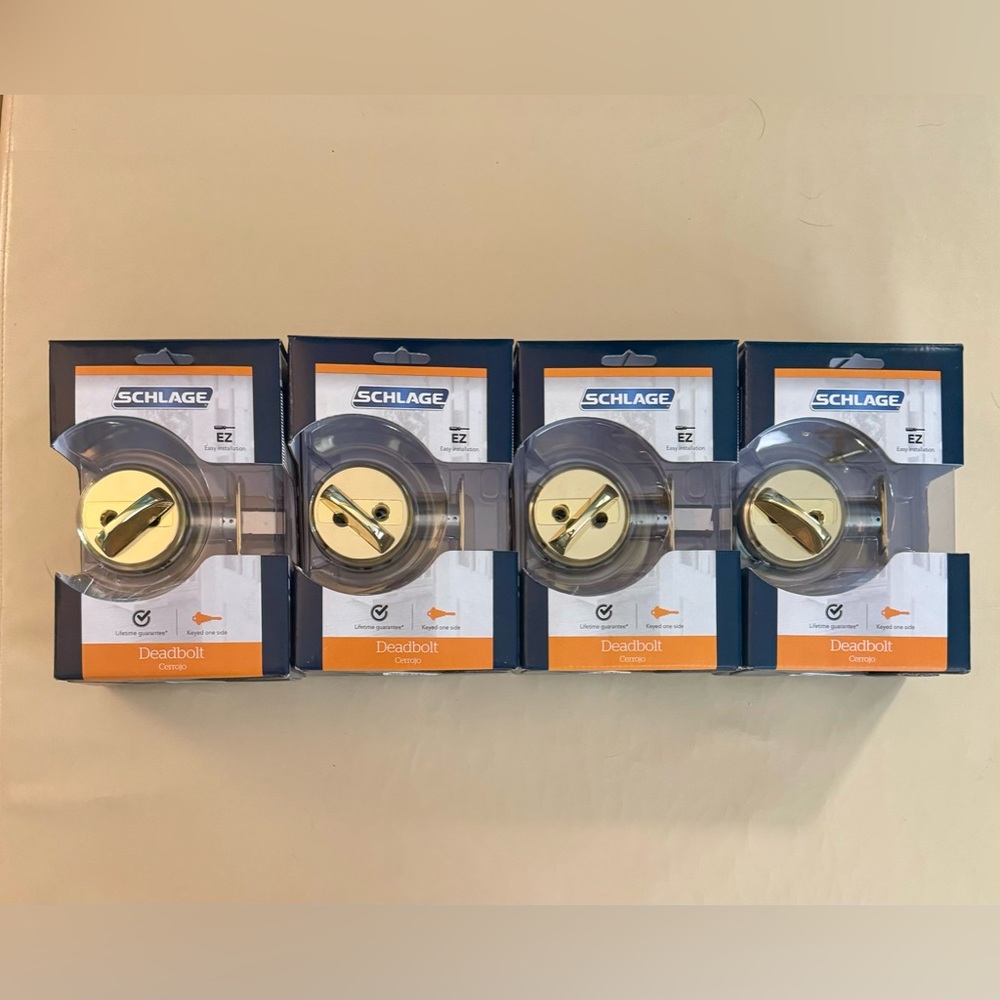 Four Schlage Bright Brass Deadbolt. Never been used & still in original box.